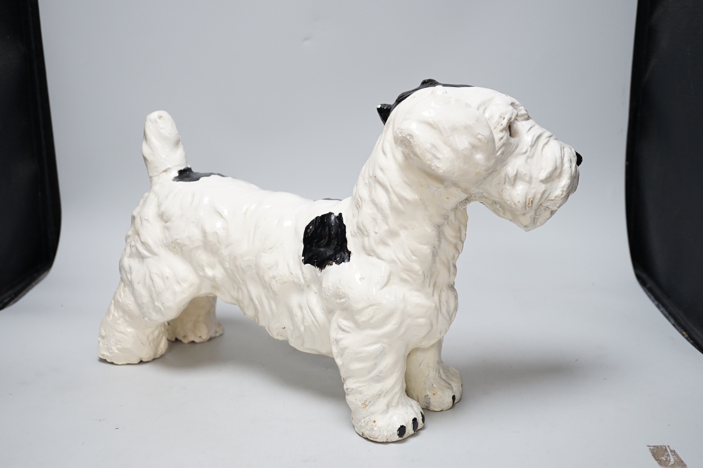 A painted plaster model of a terrier dog, 28cm high, 41cm long